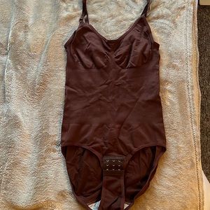 Form fitting body suite
